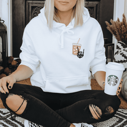Stay fueled and stylish with our new 'Fueled by Iced Coffee and Anxiety' Sweatshirt. With a skeleton hand and an iced coffee on the front and the phrase 'fueled by iced coffee and anxiety' on the back, you'll never have to worry about running low on fuel or style. Stay energized, cool, and confident in our high-quality sweatshirt!